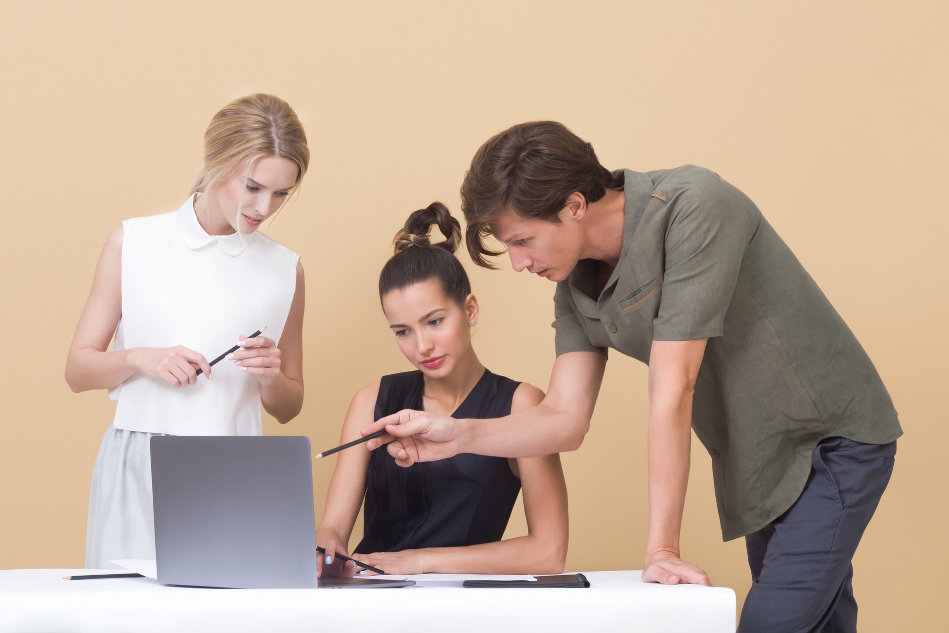two-woman-and-one-man-looking-at-the-laptop-1036641